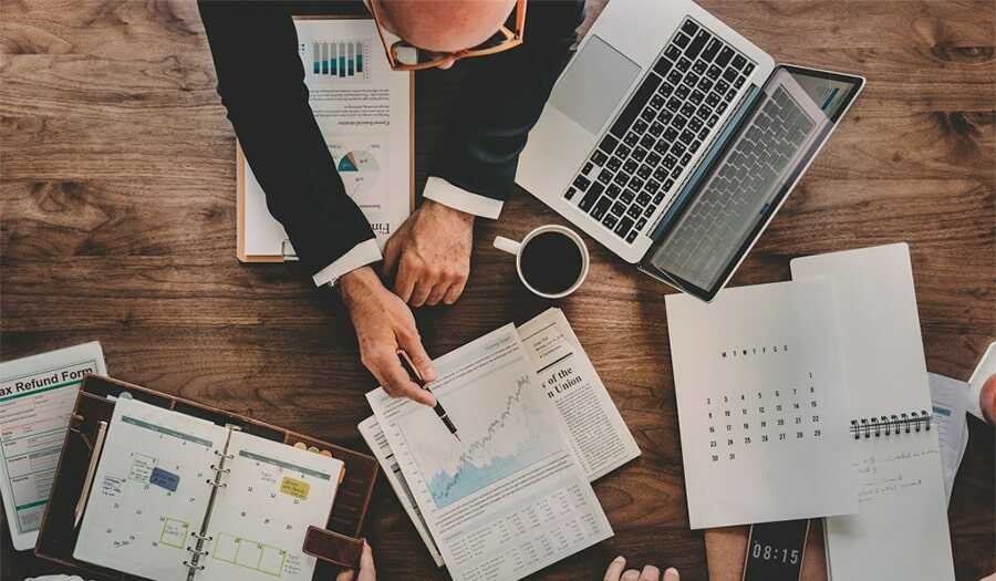 family office risk people with laptops work space area